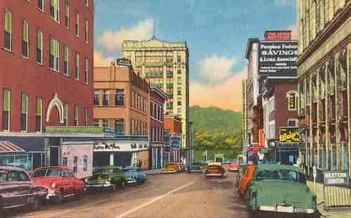 Vintage illustration of a bustling city street with classic cars, colorful buildings, and signage from the mid-20th century.